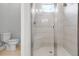 Modern bathroom with glass-enclosed shower featuring white tiling, a built-in seat, and a window at 26930 Lark Ct, Punta Gorda, FL 33955
