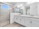 Elegant bathroom features a glass-enclosed shower and double sinks with contemporary fixtures at 26936 Lark Ct, Punta Gorda, FL 33955