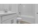 Clean bathroom showcasing a tub with tile surround and modern white vanity at 26936 Lark Ct, Punta Gorda, FL 33955