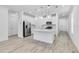 Bright kitchen featuring white cabinets, stainless steel appliances, and a large island with pendant lighting above at 26936 Lark Ct, Punta Gorda, FL 33955