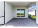 Covered patio featuring stone floors and a seamless transition to a well-manicured lawn at 26936 Lark Ct, Punta Gorda, FL 33955