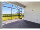 Outdoor screened porch features stone floors and views of the lush, green yard at 26936 Lark Ct, Punta Gorda, FL 33955