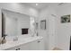 Bathroom featuring a double sink vanity, a large mirror, and ample lighting at 3417 Tallywood Ln, Sarasota, FL 34237