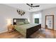 Bedroom featuring a queen bed with a ceiling fan, a window, and a full length mirror at 3417 Tallywood Ln, Sarasota, FL 34237