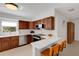 Well-lit kitchen with stainless steel appliances, a breakfast bar, and wooden cabinetry at 3417 Tallywood Ln, Sarasota, FL 34237