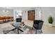 Open-concept living room with tile flooring, modern furniture, and a view of the dining area at 3417 Tallywood Ln, Sarasota, FL 34237
