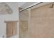 Tiled shower stall featuring updated shower-head and glass enclosure at 3417 Tallywood Ln, Sarasota, FL 34237