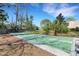 Community shuffleboard with multiple courts surrounded by lush landscaping and mature trees at 3417 Tallywood Ln, Sarasota, FL 34237