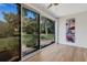 Sunroom featuring sliding glass doors, laminate floors and natural light at 3417 Tallywood Ln, Sarasota, FL 34237