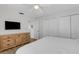 Bright bedroom featuring wooden floors, closet space, dresser and a view into the bathroom at 3708 Chinaberry Rd, Bradenton, FL 34208