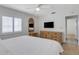 Bedroom featuring wooden floors, a window with shutters, and a wooden dresser with a mirror at 3708 Chinaberry Rd, Bradenton, FL 34208