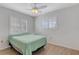 Well lit bedroom with a window, wooden floors and a fan at 3708 Chinaberry Rd, Bradenton, FL 34208