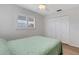 Bedroom with wooden floors, closet, and a window with shutters at 3708 Chinaberry Rd, Bradenton, FL 34208