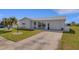 Inviting home with a well-manicured lawn, mature landscaping, and a spacious driveway leading to the garage at 3708 Chinaberry Rd, Bradenton, FL 34208
