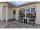 Cozy front porch with seating, creating a welcoming entrance to the home with a view to the outdoors at 3708 Chinaberry Rd, Bradenton, FL 34208