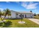 Charming single-story home with manicured lawn, beautiful palm trees, and a welcoming front entrance at 3708 Chinaberry Rd, Bradenton, FL 34208