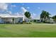 Lush golf green and manicured landscaping with view of charming homes in River Runs Plantation at 3708 Chinaberry Rd, Bradenton, FL 34208