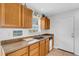 Kitchen featuring oak cabinets, laminate countertops, and a stainless steel sink at 3708 Chinaberry Rd, Bradenton, FL 34208