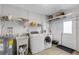 Laundry room featuring a sink, washer, dryer, and shelves for storage at 3708 Chinaberry Rd, Bradenton, FL 34208
