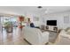 Bright and airy living room featuring tile floors, neutral decor, and a seamless flow to the kitchen at 3708 Chinaberry Rd, Bradenton, FL 34208