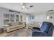 Comfortable living room with neutral paint, ceiling fan, tiled floor, and plenty of natural light at 3708 Chinaberry Rd, Bradenton, FL 34208