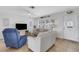 Bright living room featuring comfortable seating, large windows, and a seamless transition to the home's entryway at 3708 Chinaberry Rd, Bradenton, FL 34208