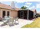 Backyard patio with dining set and a view of the screened-in porch at 3739 Kingston Blvd, Sarasota, FL 34238
