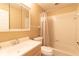 Well-lit bathroom featuring a shower with a curtain, toilet, and sink at 3739 Kingston Blvd, Sarasota, FL 34238