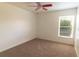 Carpeted bedroom featuring a ceiling fan and a window with plenty of natural light at 3739 Kingston Blvd, Sarasota, FL 34238