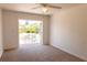 Bedroom with carpet flooring and glass door access to backyard at 3739 Kingston Blvd, Sarasota, FL 34238