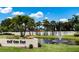 Picturesque Gulf Gate East community sign in a lush setting with water feature and mature palm trees at 3739 Kingston Blvd, Sarasota, FL 34238