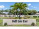 Manicured entrance to Gulf Gate East featuring lush landscaping and mature palm trees at 3739 Kingston Blvd, Sarasota, FL 34238