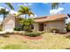 Inviting single-story home showcasing a well-maintained lawn, tropical landscaping, and a charming entrance at 3739 Kingston Blvd, Sarasota, FL 34238