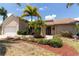 Charming single-story home with lush tropical landscaping, well-manicured lawn, and welcoming entrance at 3739 Kingston Blvd, Sarasota, FL 34238