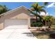 Attached two-car garage with a clean driveway surrounded by manicured landscaping and mature trees at 3739 Kingston Blvd, Sarasota, FL 34238