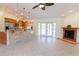 Open concept living space with tiled floors, stone fireplace, and seamless connection to the kitchen at 3739 Kingston Blvd, Sarasota, FL 34238