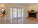 Spacious living area showcasing French doors, tile flooring, and a charming fireplace at 3739 Kingston Blvd, Sarasota, FL 34238