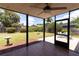 View from a screened-in porch onto the large grassy backyard with a patio set at 3739 Kingston Blvd, Sarasota, FL 34238