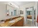 Bathroom featuring a granite countertop, sink, and vanity with decorative mirrors and lighting at 406 116Th E St, Bradenton, FL 34212