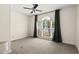 Neutral bedroom with large window letting in natural light and ceiling fan at 406 116Th E St, Bradenton, FL 34212