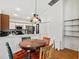 Eat-in kitchen featuring stainless steel appliances and a colorful, decorative hanging light fixture at 406 116Th E St, Bradenton, FL 34212