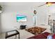 Bright living room with high ceilings, ceiling fan, and a flatscreen TV for entertainment at 406 116Th E St, Bradenton, FL 34212