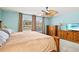 Cozy main bedroom with a ceiling fan, windows, and dressers for ample storage space at 406 116Th E St, Bradenton, FL 34212