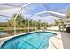 Relaxing screened-in pool with a sunny patio overlooking a lush private backyard and tranquil pond at 406 116Th E St, Bradenton, FL 34212