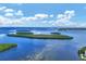 Beautiful water view featuring small, lush islands and serene blue waters beneath a sunny sky with fluffy clouds at 4390 Exeter Dr # I305, Longboat Key, FL 34228
