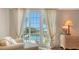 Balcony view of the beach and swimming pool, with sheer drapes at 4473 Gulf Of Mexico Dr, Longboat Key, FL 34228