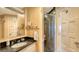 Bright bathroom with a black marble sink and a walk-in shower with glass doors at 4473 Gulf Of Mexico Dr, Longboat Key, FL 34228