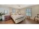 Comfortable bedroom with hardwood floors, a ceiling fan, and natural light at 4473 Gulf Of Mexico Dr, Longboat Key, FL 34228