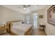 Cozy bedroom featuring a neutral palette, ceiling fan, and an en-suite bathroom with a step-in shower at 4473 Gulf Of Mexico Dr, Longboat Key, FL 34228