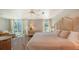 Well-lit primary bedroom with a cozy sitting area, plush bedding, and large windows at 4473 Gulf Of Mexico Dr, Longboat Key, FL 34228